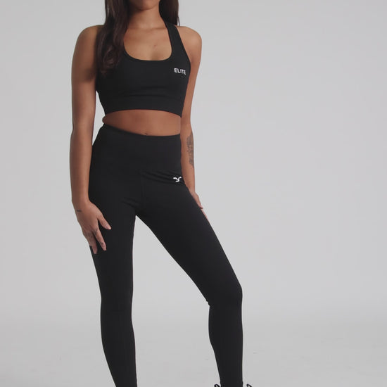 Envolve Midnight black cropped sports bra with racer back and scoop neck.