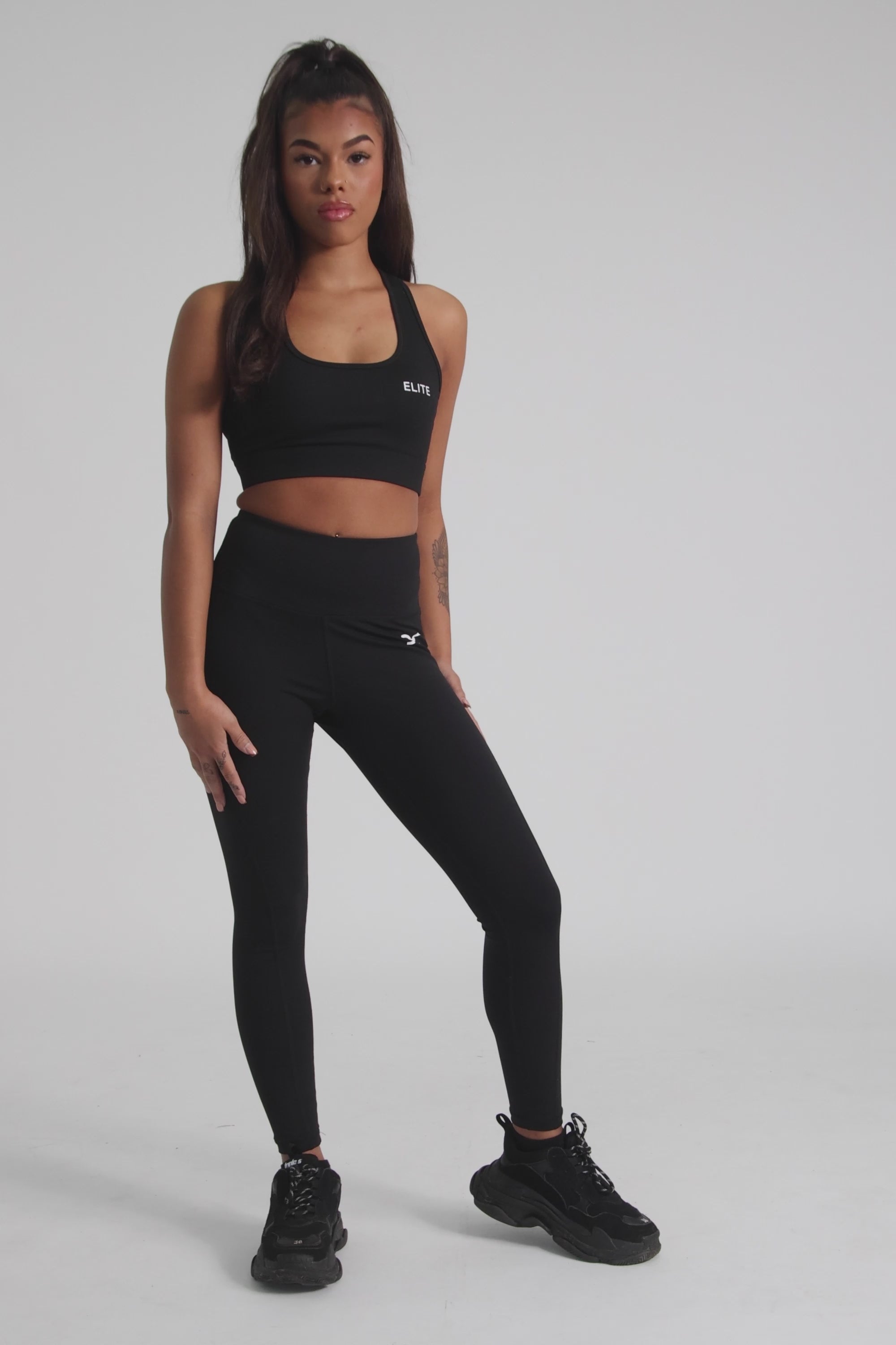 Envolve Midnight black cropped sports bra with racer back and scoop neck.